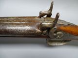 a close up of an old gun with a wooden handle
