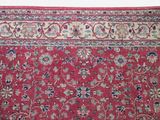 an image of a red rug with a floral design on it