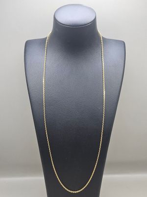 a gold chain necklace on a mannequin display