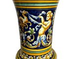 a blue and yellow vase with a lion on it