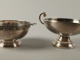 pair of silver plated bowls with handles on pedestals