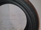 a close up of a tire on a table with a wall in the background
