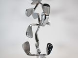 a metal sculpture made to look like golf clubs