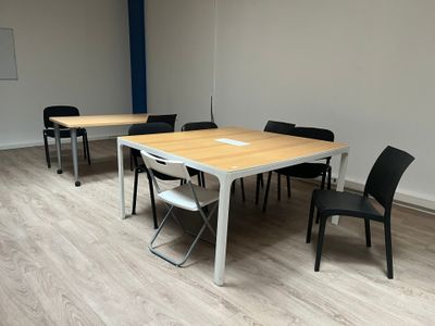 a table and chairs in a room with wood flooring
