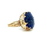 a close up of a gold ring with a lapis stone