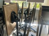 many chairs and a table in a room with a lot of windows
