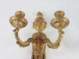 a gold candle holder with two candles on it