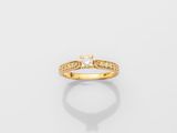 a yellow gold ring with a single diamond