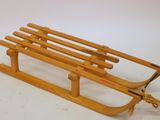 a wooden sled with a rope attached to it