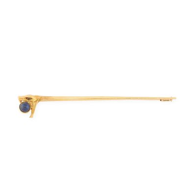 an image of a gold stick with a blue stone on it