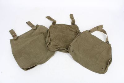 two pieces of military equipment are laying on a white surface