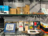 a glass shelf with books and other items on it