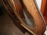 a wooden chair with a mirror on top of it