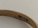 a close up of a gold ring with a diamond on it