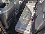 the back seat of a car with a bottle of water in it