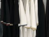a closet with clothes hanging on a rack in a room