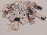many tubes of paint sitting on a white surface