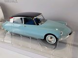 a model of a blue car on display in a display case