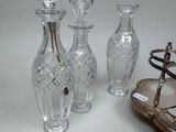 three glass vases sitting next to a pair of shoes