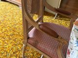 a chair and a table in a room with a yellow carpet