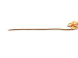 a stick with a knot on it on a white surface