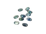 a group of blue and green labradorite stones on a white surface