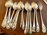 a lot of silver spoons and spoons on a table