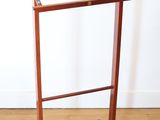 a wooden coat rack with a wooden hanger on it