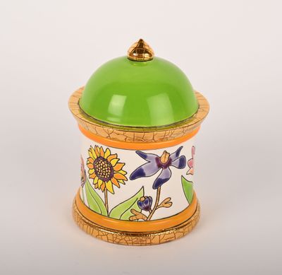 un récipient vert et jaune orné d'un motif floral