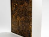 a close up of a wooden box with a painting on it