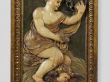 an old picture of a woman holding a baby in her lap