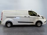 the white van is parked in a room with a gray floor