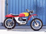 a red and yellow motorcycle parked in front of a blue garage door