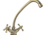 an image of a faucet with a brass finish on a white background
