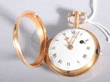 a gold pocket watch with roman numerals on it
