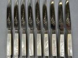 six knives are lined up next to each other on a table