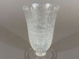 a glass vase that is sitting on a table