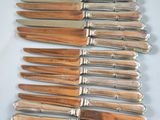 a lot of knives that are on a white plate