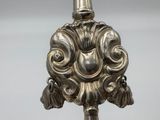 a close up of a silver object on a stand