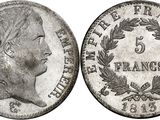 a silver coin with a woman ' s head and laurels on it