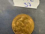 a close up of a gold coin with a sticker on it