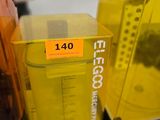 a yellow blender sitting on a counter next to other items