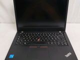 the laptop is open on a white surface with a black keyboard