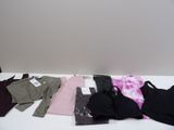 a lot of clothes that are on a white table