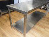 a stainless steel table in the middle of a kitchen