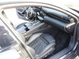 the interior of a car with the door open and the driver ' s seat down