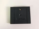 the back side of a black plastic box with a button on it