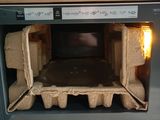 a box of eggs inside of a microwave on the counter