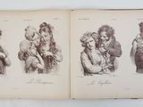 an old book with a drawing of a woman holding a baby