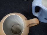 two coffee cups sitting next to each other on a table